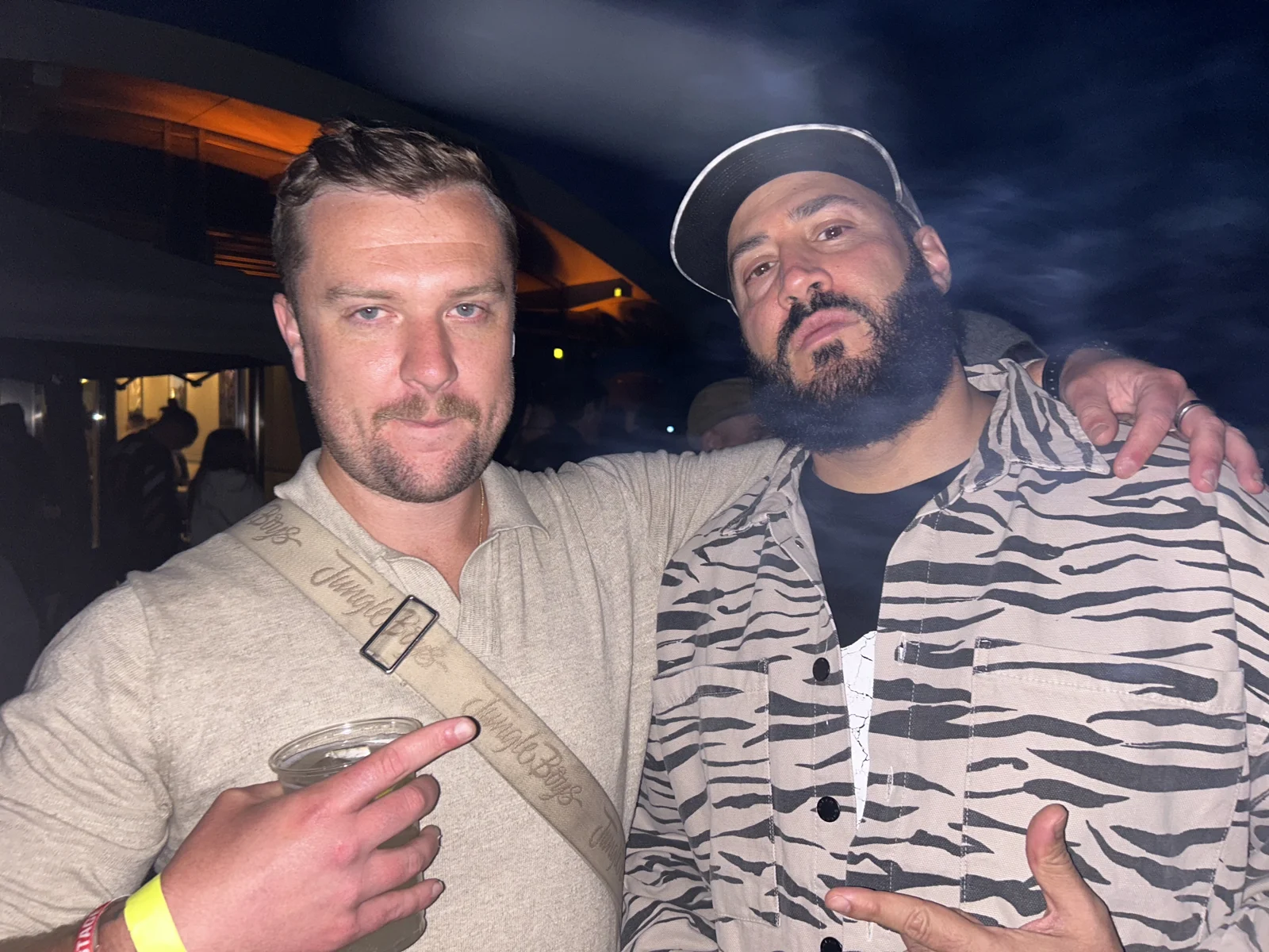 Luc Carlin (LMC): standing beside a guest at a nighttime gathering