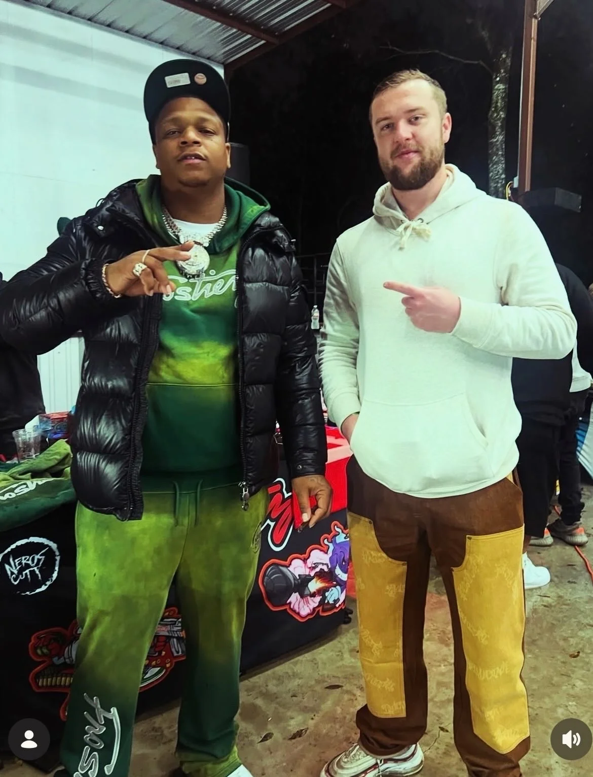 Luc Carlin (LMC): standing beside a guest indoors wearing a light hoodie