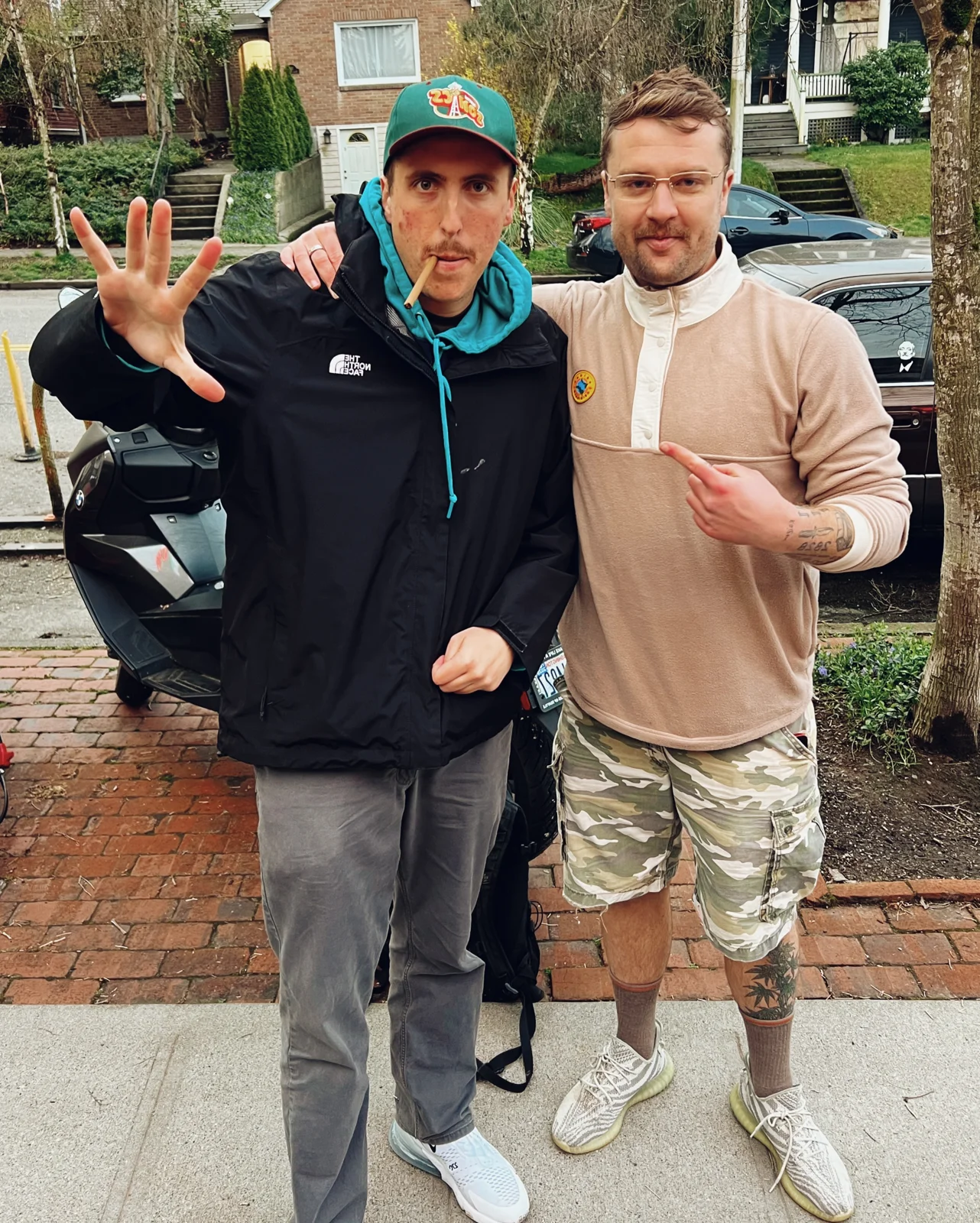 Luc Carlin (LMC): standing beside a guest on a residential sidewalk