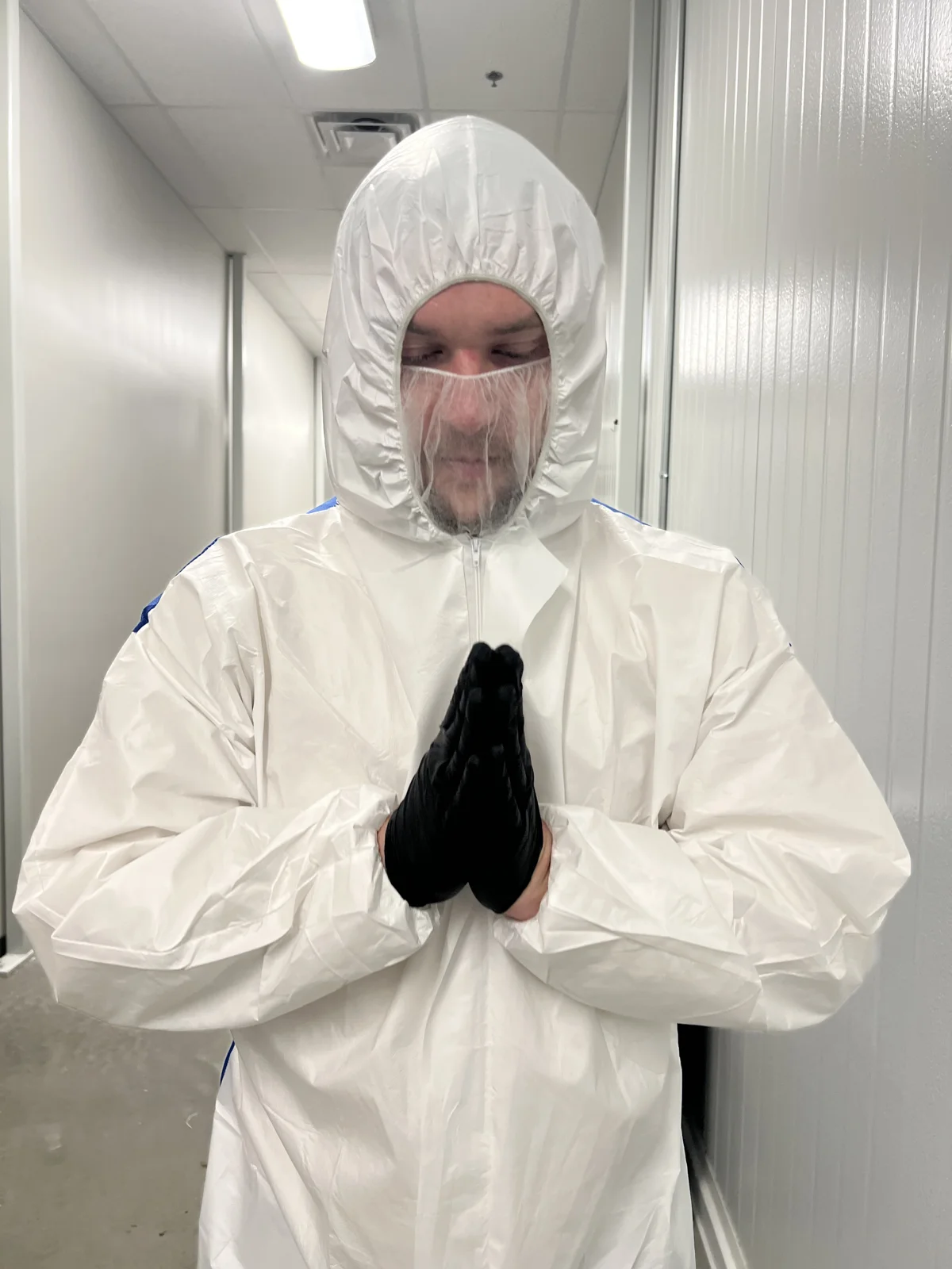 Luc Carlin (LMC): wearing a white protective suit and black gloves
